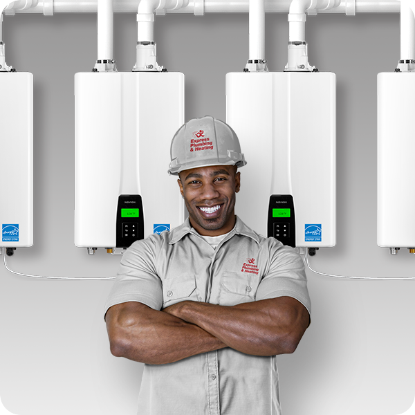a technician with crossed arms in front of multiple white tankless Navien water heaters