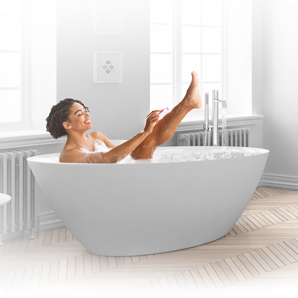 woman in a white bathtub, smiling