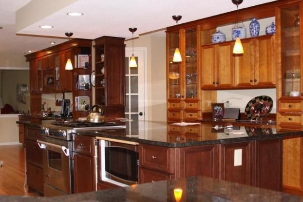 A kitchen with wooden cabinets and granite counter tops