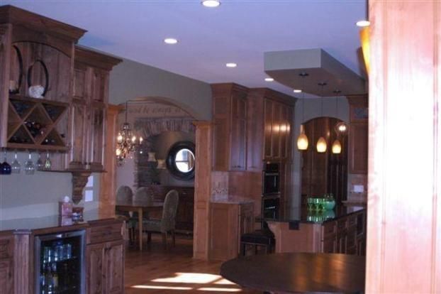 A kitchen with wooden cabinets and a wine cooler