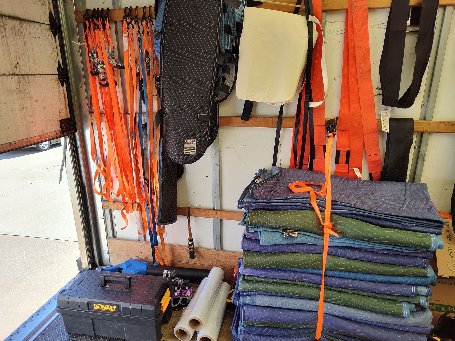 Colorful rescue gear, ropes, and folded blankets organized on shelves in a storage area.