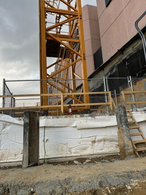 A construction site with a yellow crane 