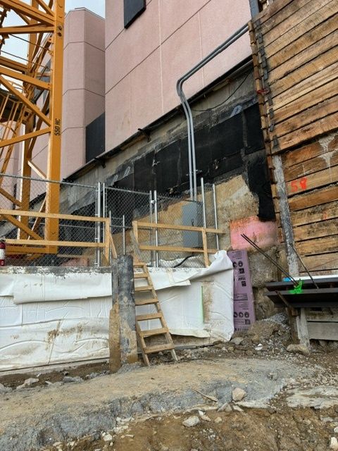 A construction site with a wooden wall and stairs