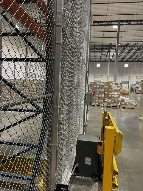 A warehouse with a chain link fence 