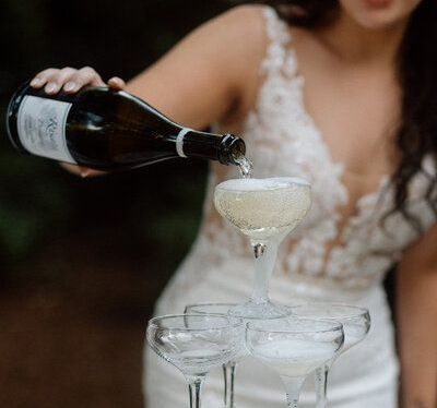 Bride pouring champagne into glasses