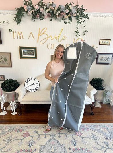 Customer holding new wedding dress
