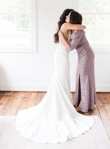 Bride and mother of the bride embracing