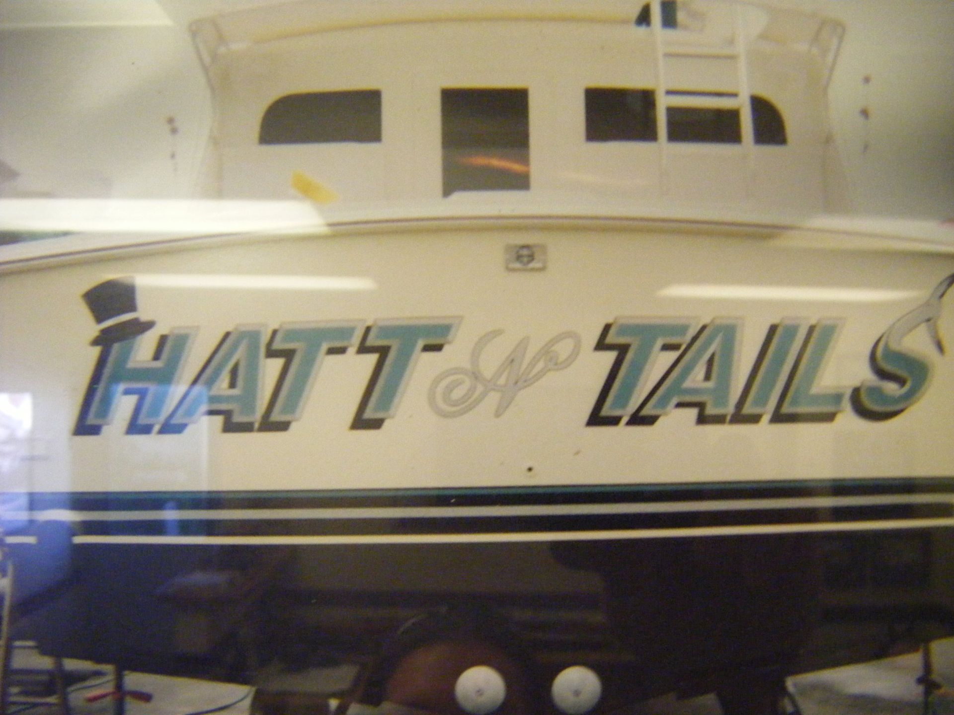 A picture of a boat that says hatt & tails