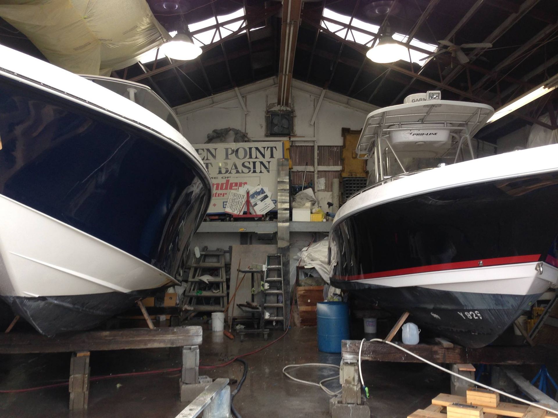 Two boats in a warehouse with a sign that says en point basin