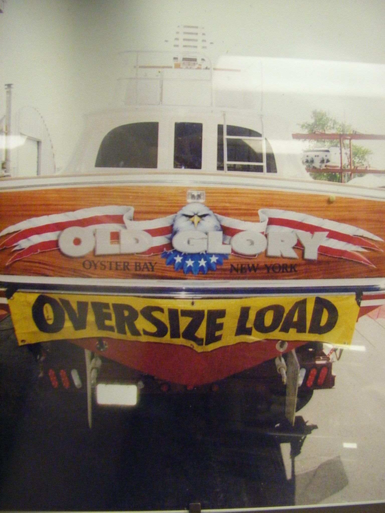 An old glory boat has an oversize load sign on the back