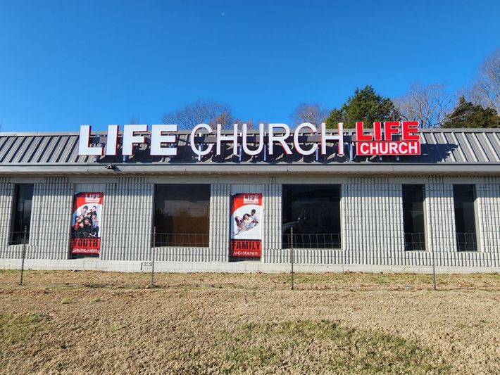 A building with a sign that says `` life church '' on it.