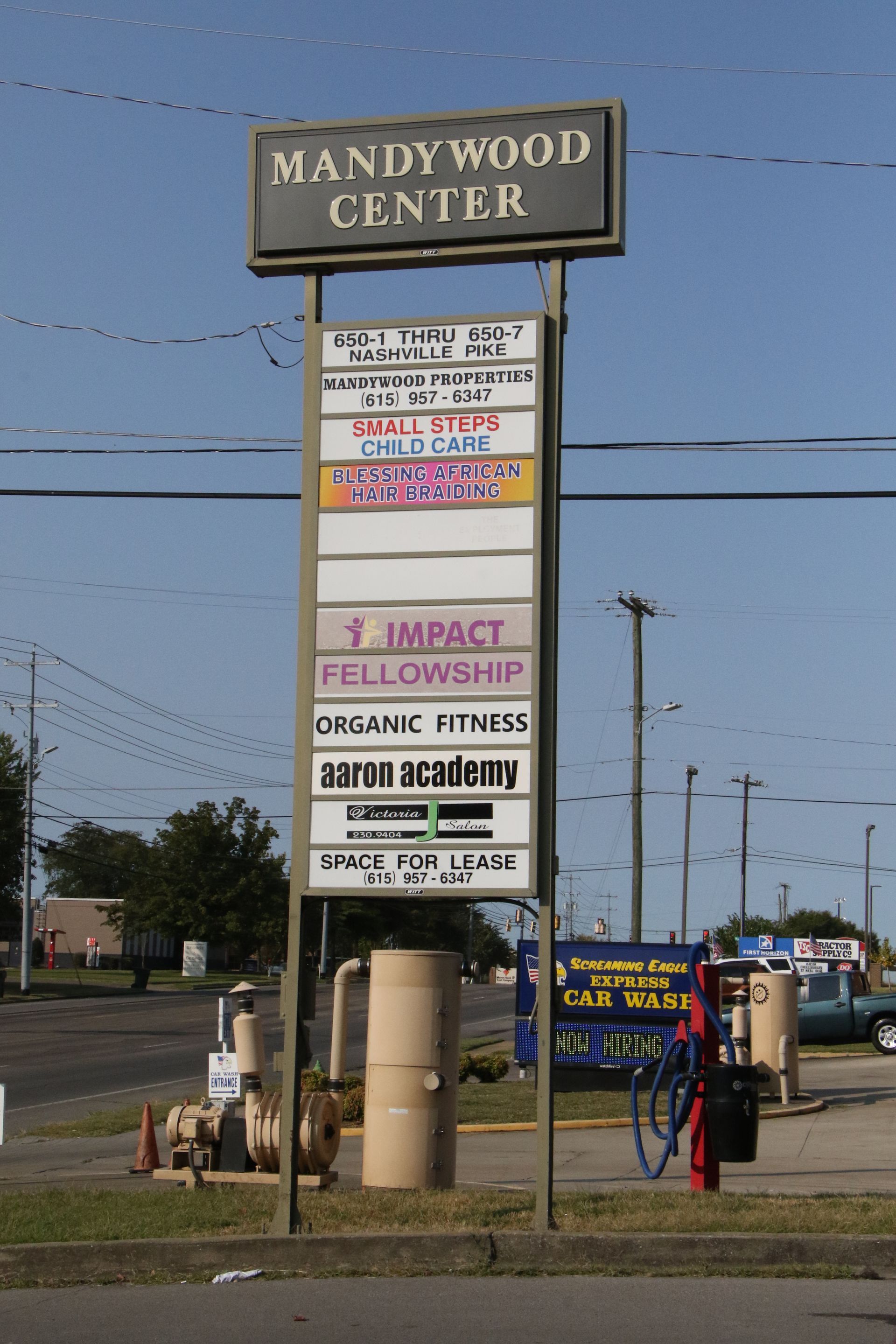 A sign for the mandy wood center sits on the side of the road