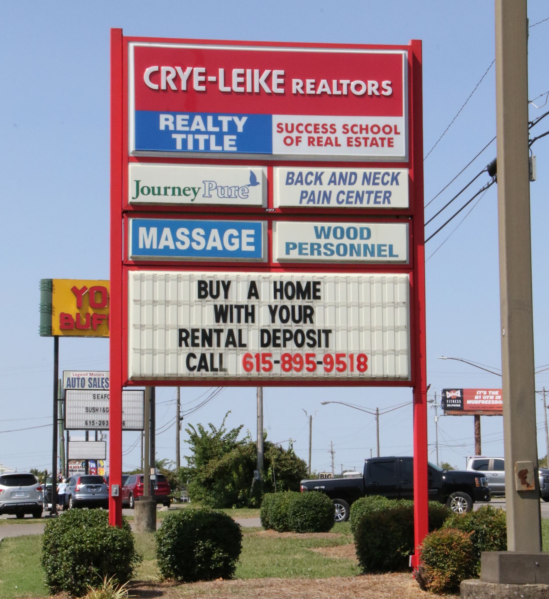 A red and white sign for crye-leike realtors