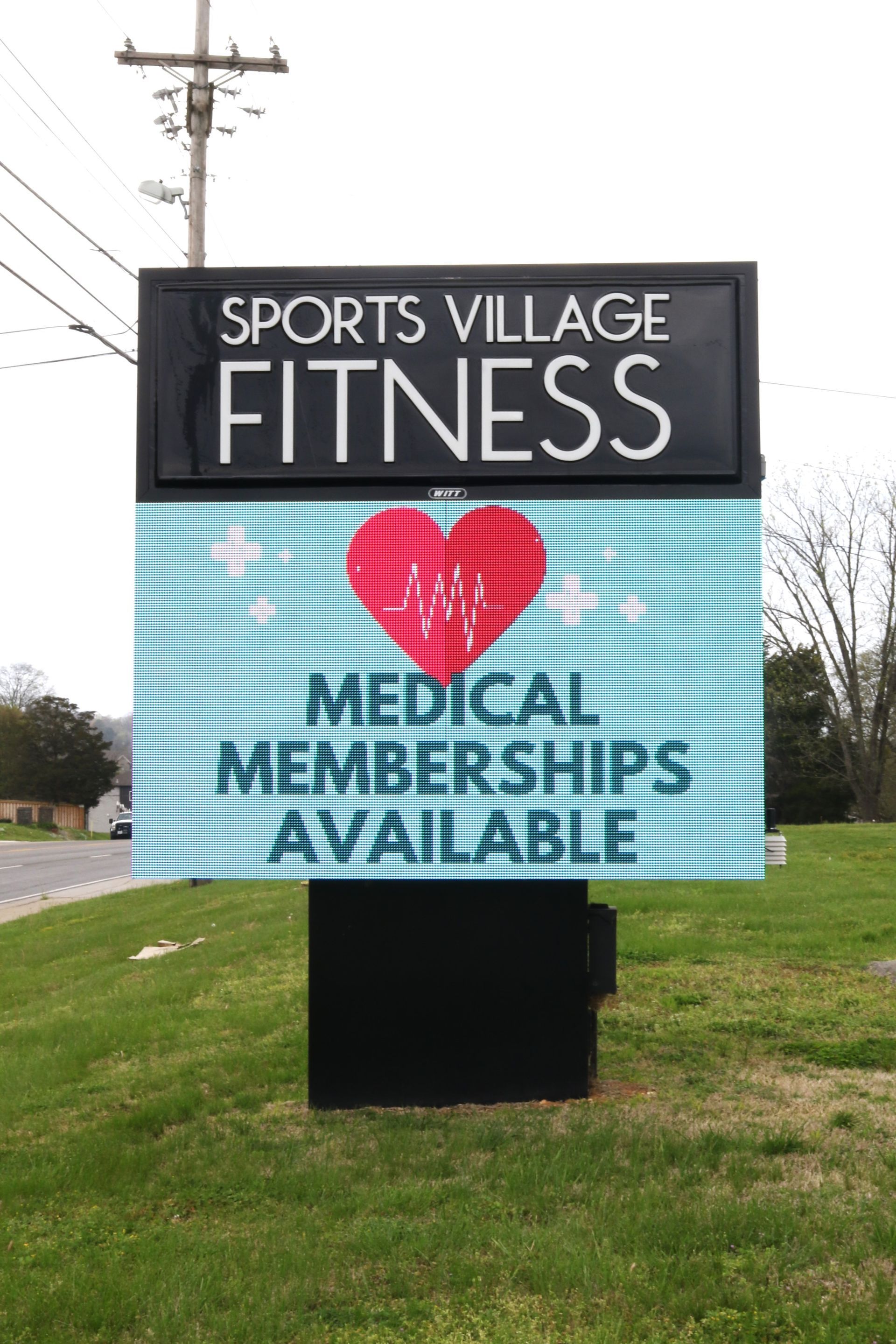 A sign that says sports village fitness medical memberships available