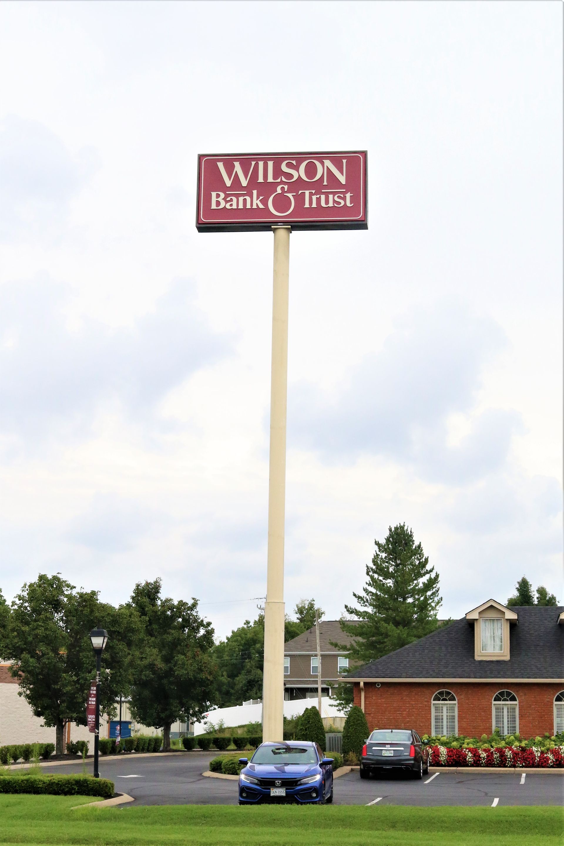 A car is parked in front of a wilson bank and trust sign