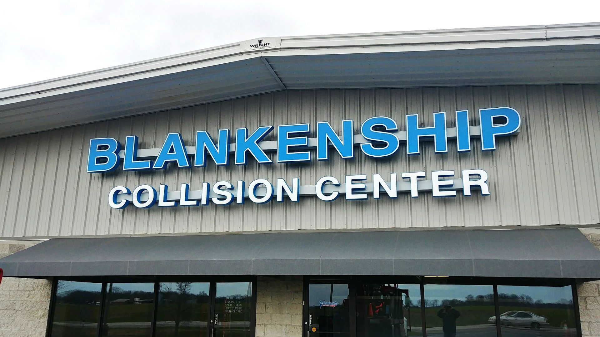 A building with a sign that says blankenship collision center