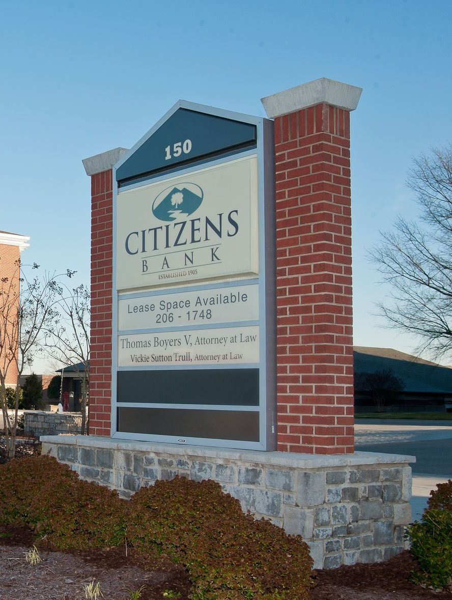 A brick building with a citizens bank sign in front of it