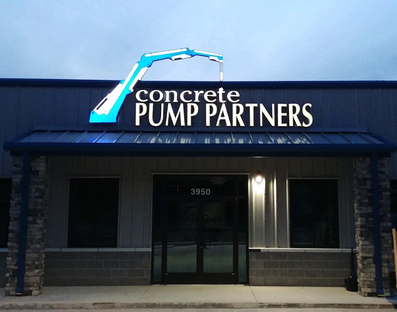 A building with a sign that says concrete pump partners