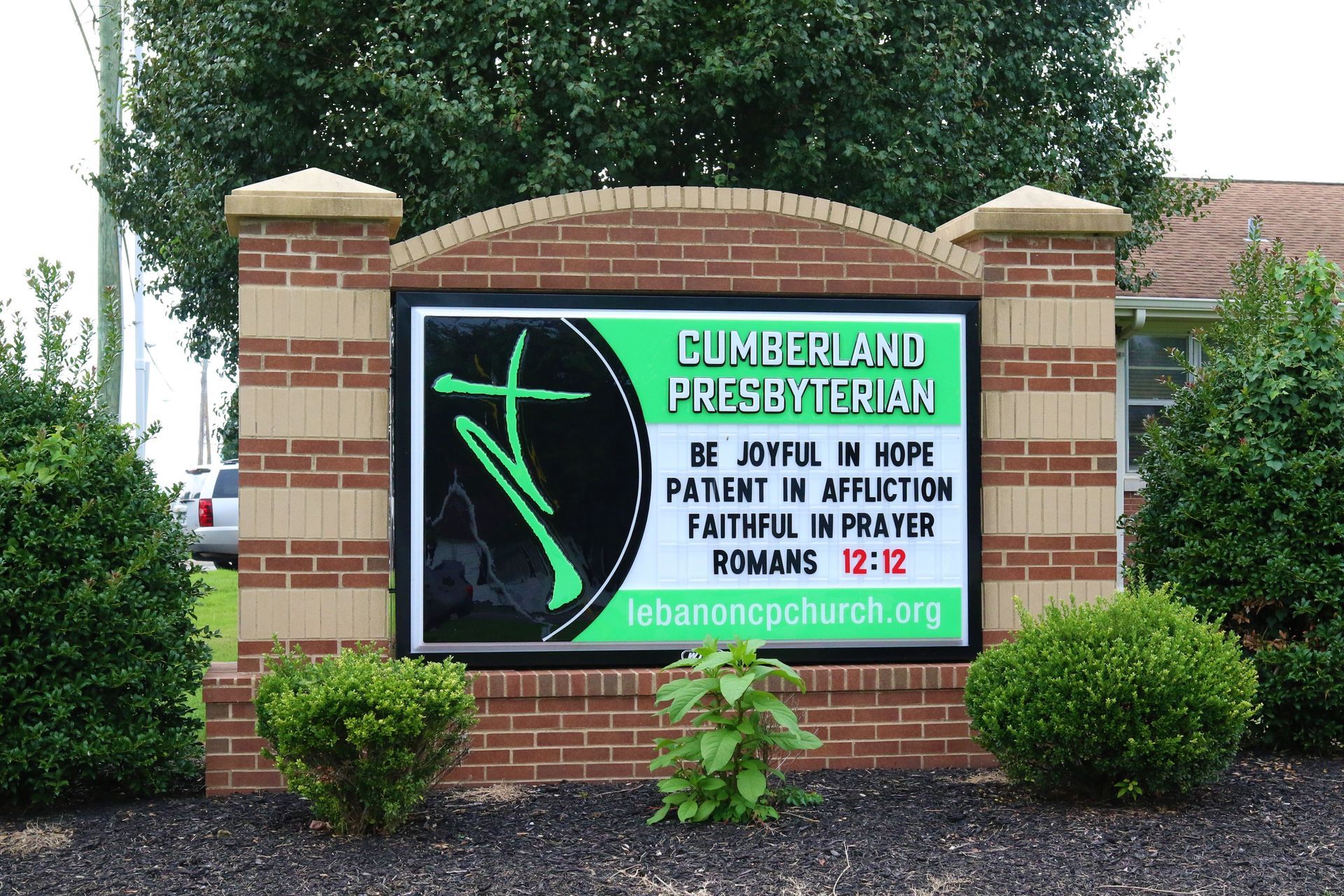 A sign for cumberland presbyterian has a cross on it