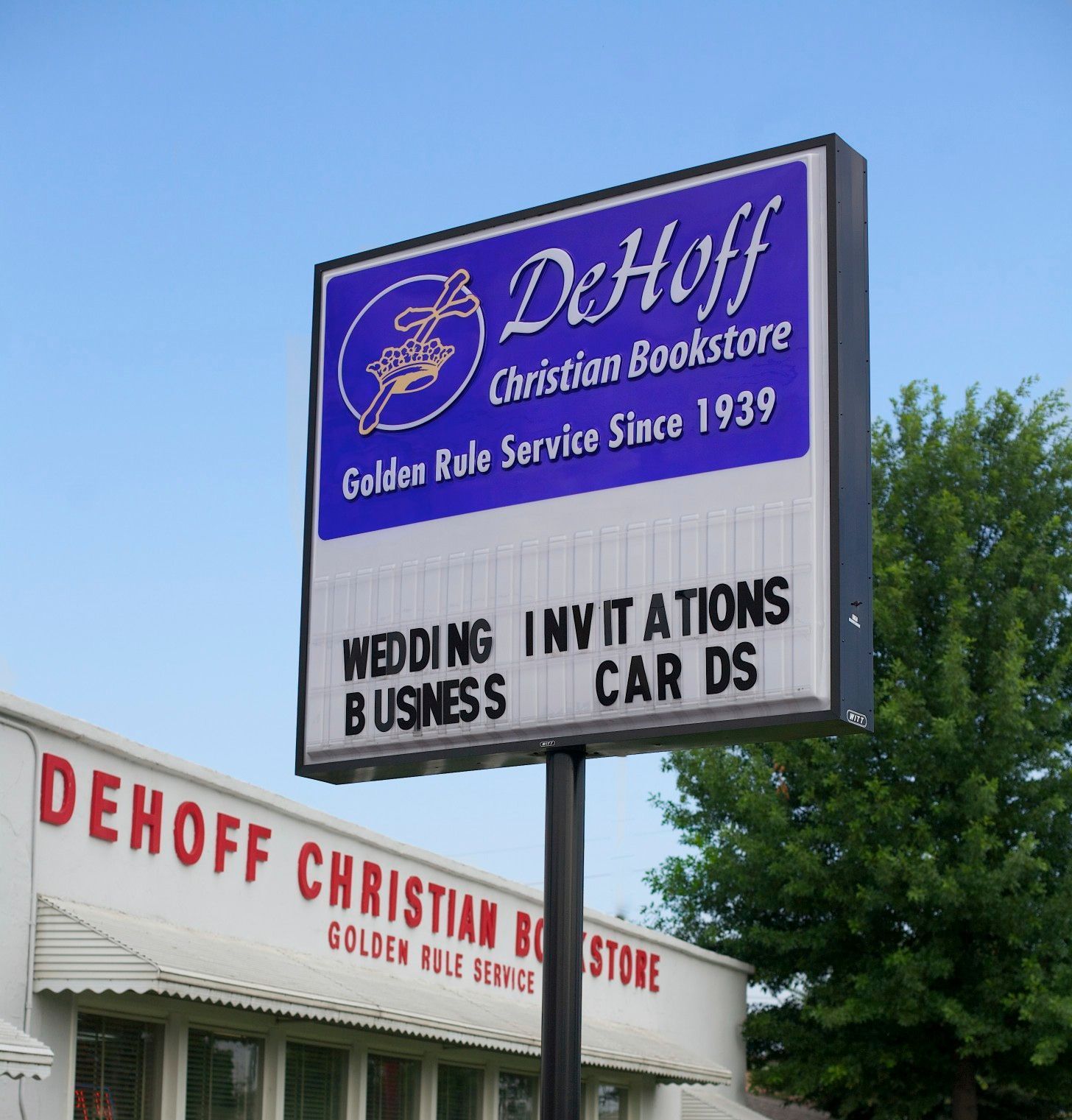 A white building with a sign that says dehoff on it