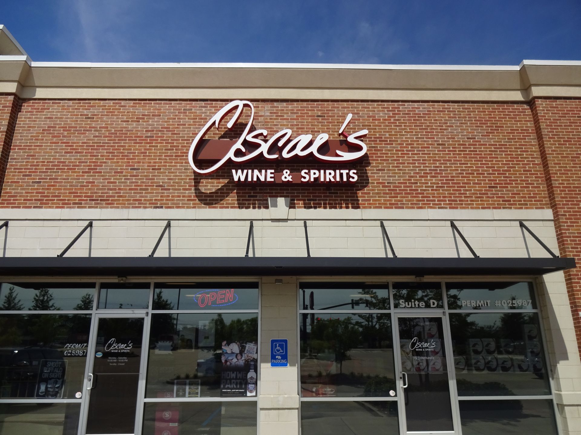Oscar 's wine and spirits is located on a brick building