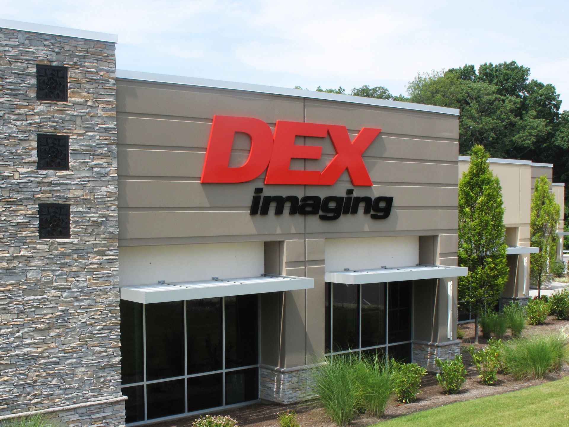 A large building with the word dex imaging on it