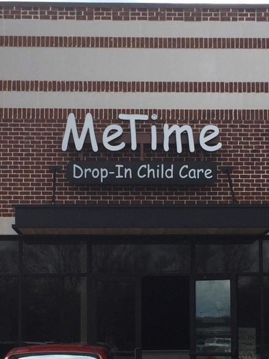 A brick building with a sign that says metime drop-in child care