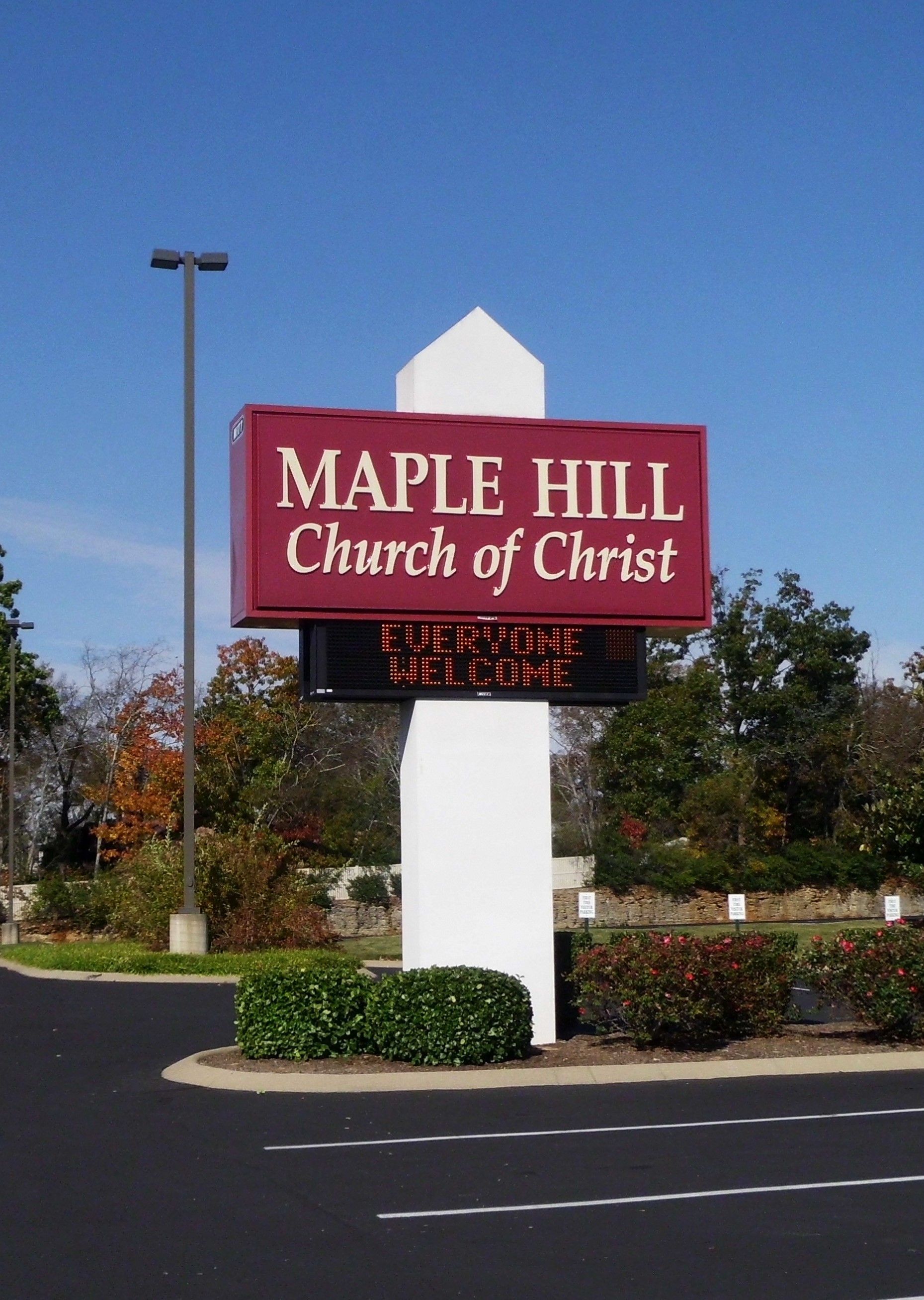 A red sign for maple hill church of christ