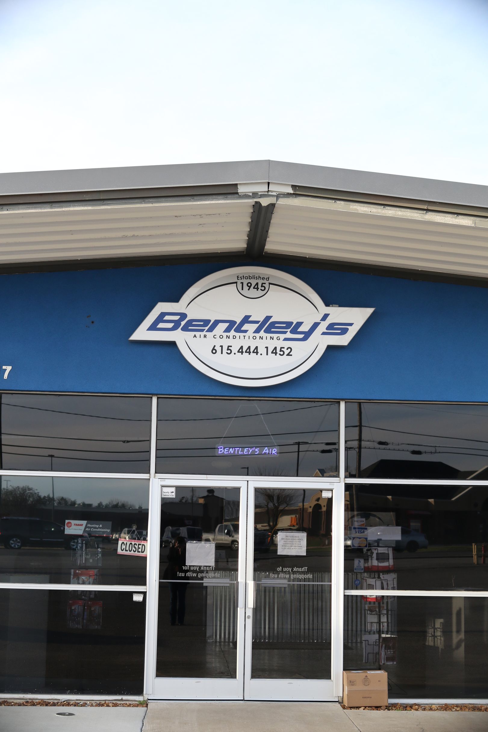 A store front with a blue sign that says bentley 's