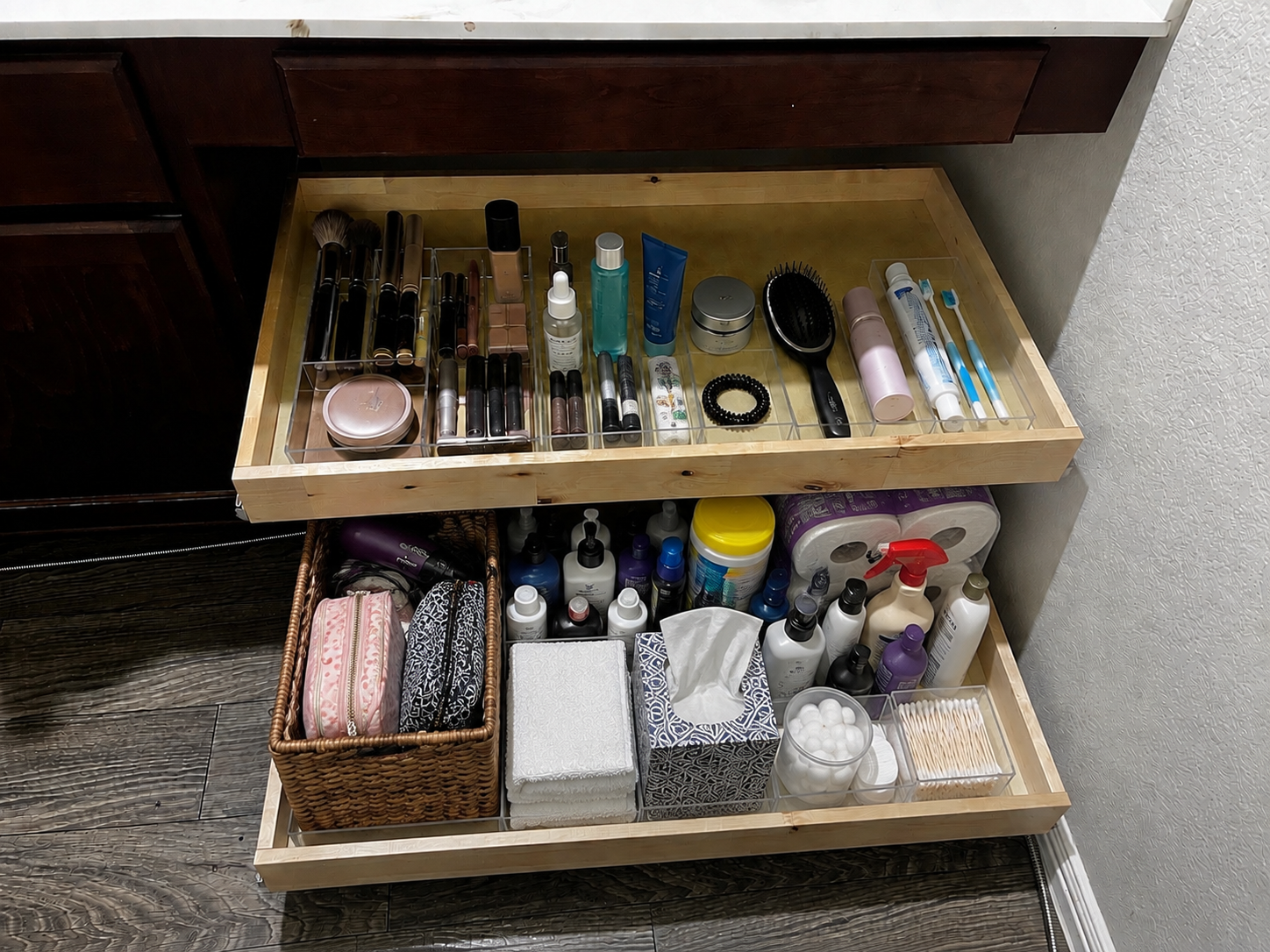 Custom pull-out drawers installed in an unused vanity knee space, providing organized bathroom stora