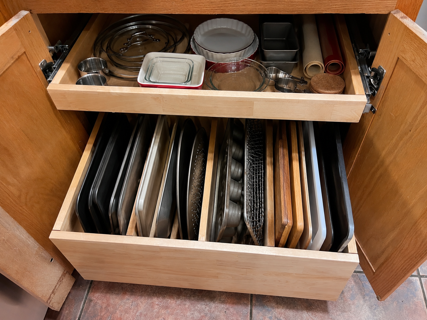 Custom pullout shelves with a tray divider pull-out organizing cookie sheets, baking pans, cutting b