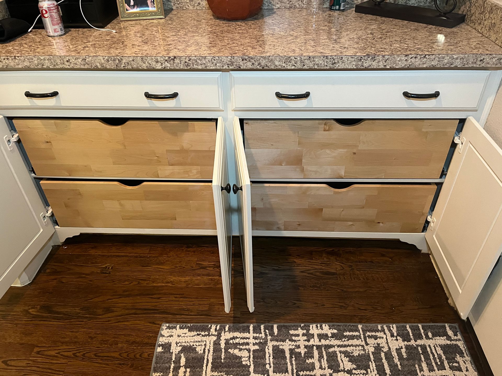 Custom heavy-duty pull-out shelves installed in a kitchen cabinet in Plano, TX