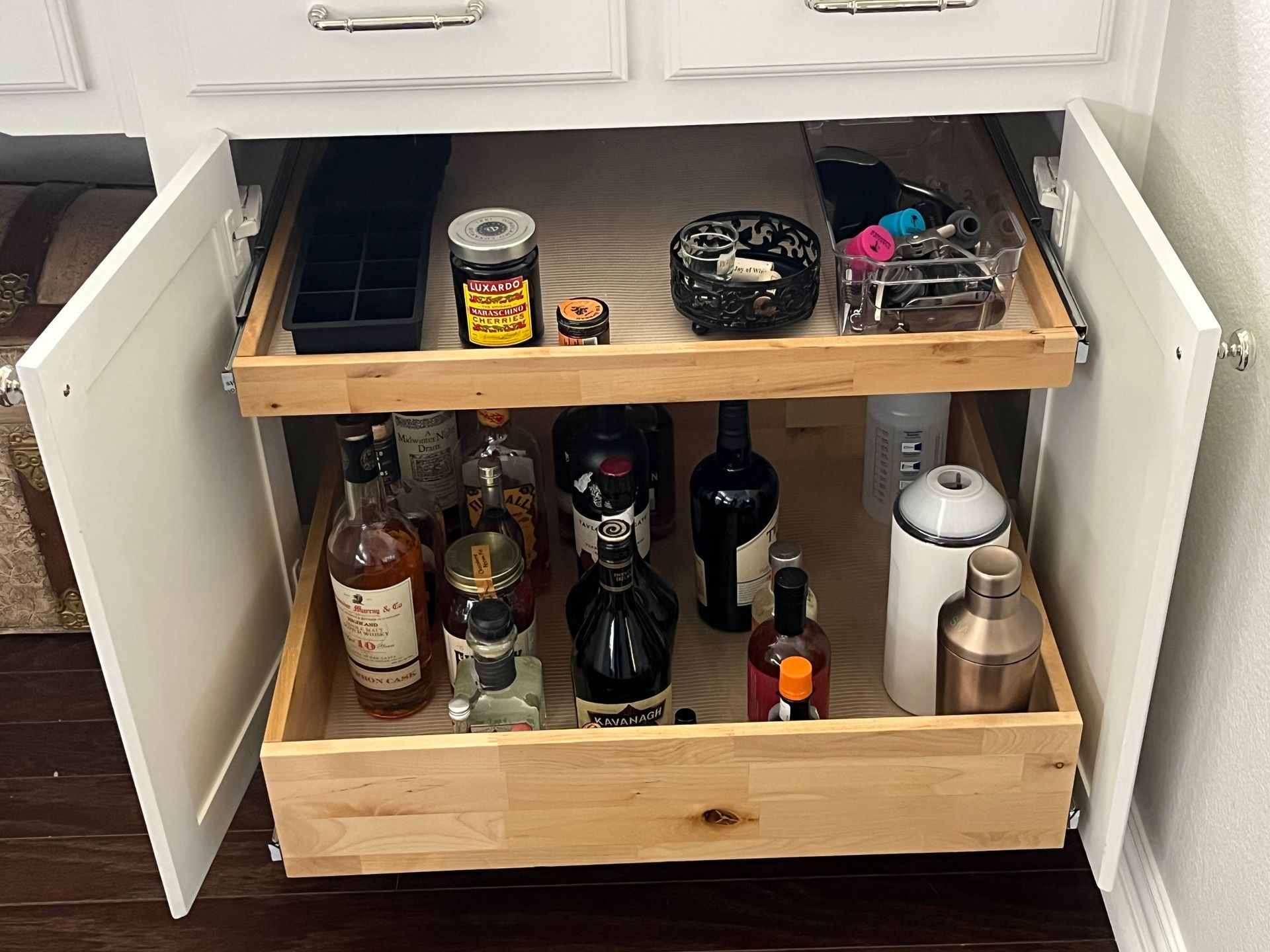 Custom pullout shelves for liquor storage with tall bottle storage and upper accessory shelf in Dall