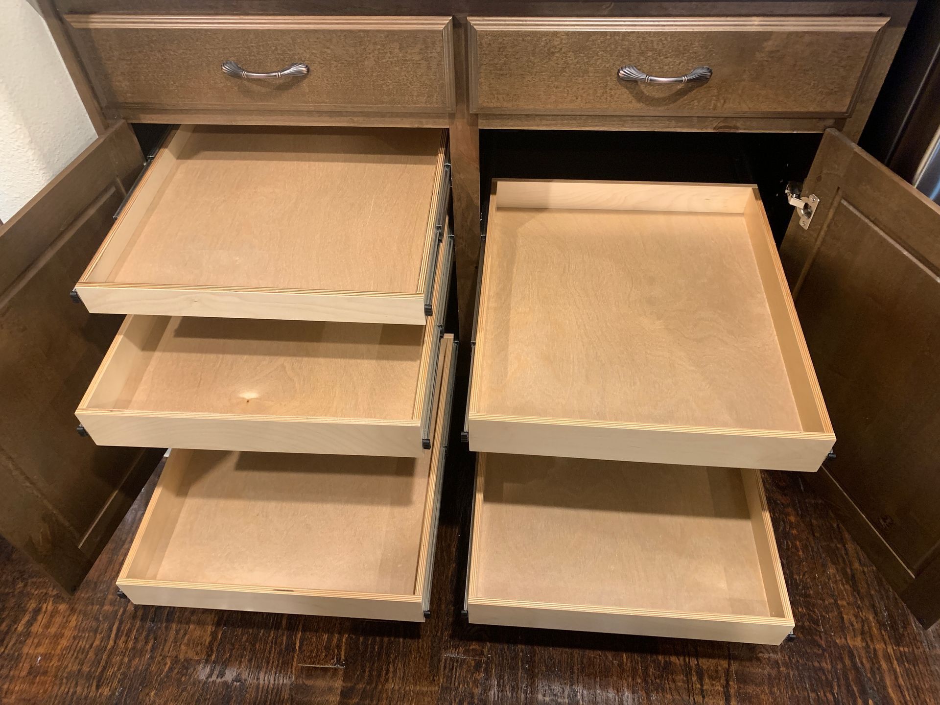 Cabinet with pull-out wooden shelves; two doors open showing three shelves on each side.