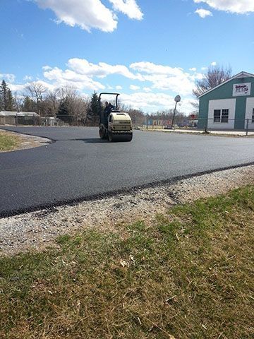 A roller is rolling asphalt on a road.