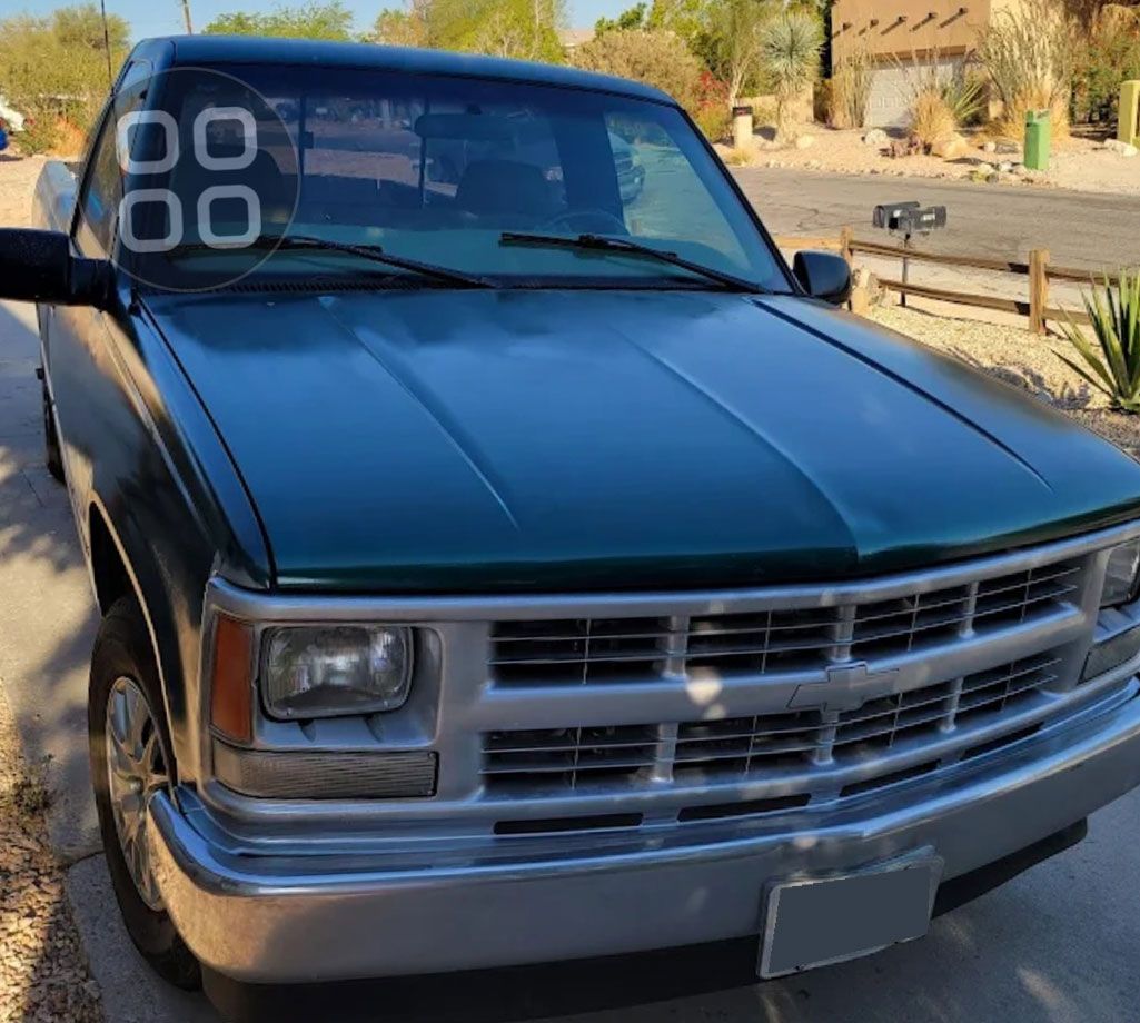Black pickup truck parked on a sunny street