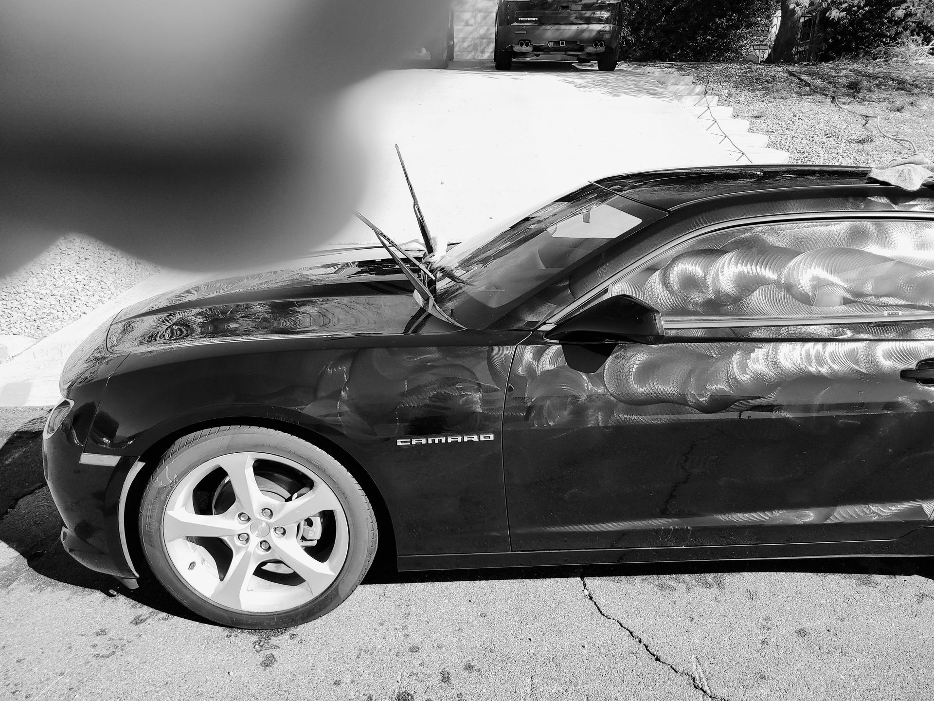 Black sedan with front-end damage