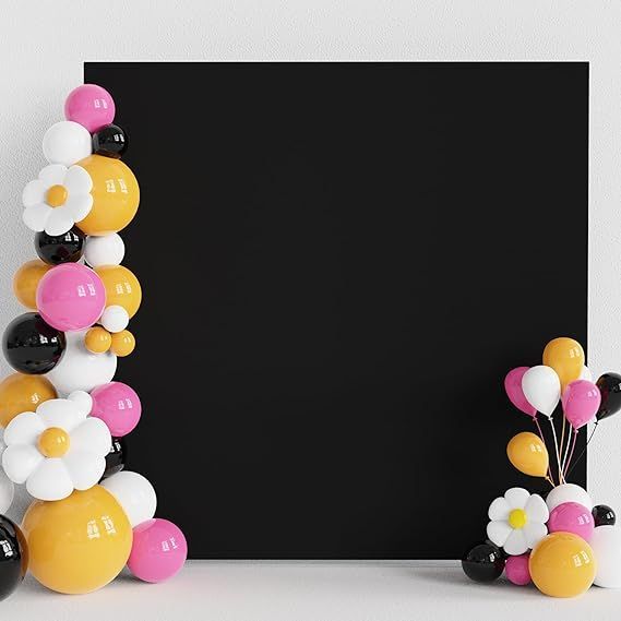 A black, square backdrop with balloons on both sides