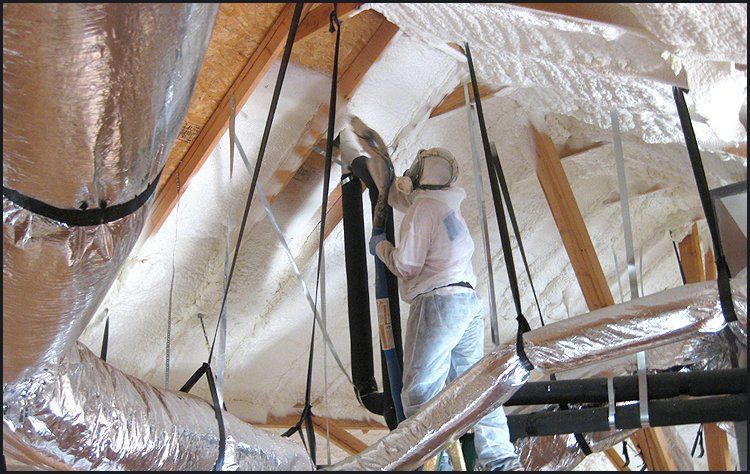 Spraying foam on ceiling