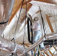 Spraying foam on ceiling.