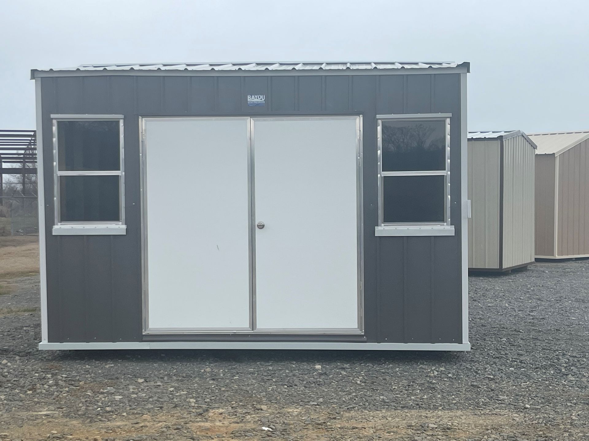 Gray portable building with white door
