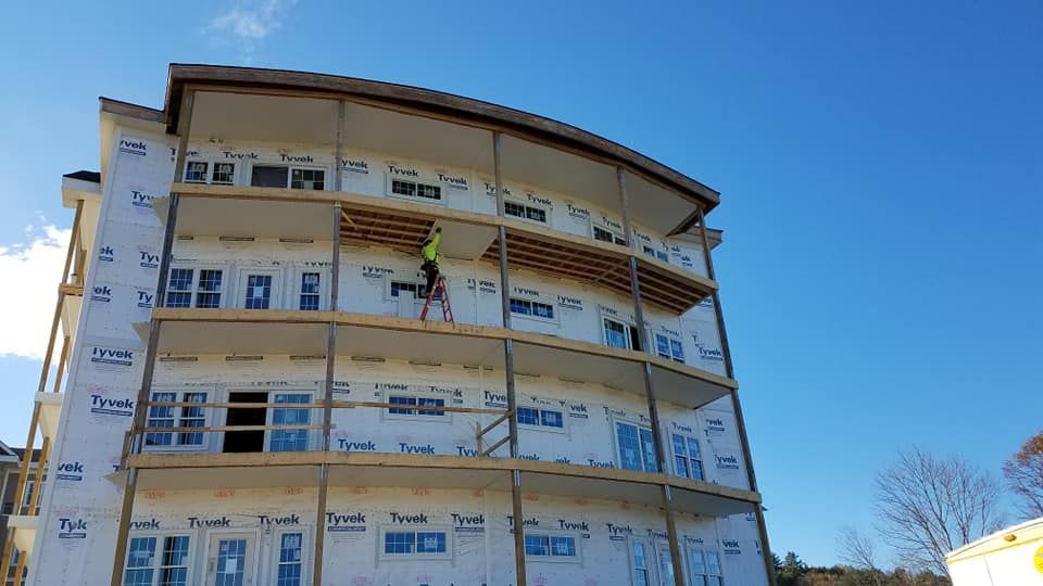 A large building under construction with a blue sky in the background.