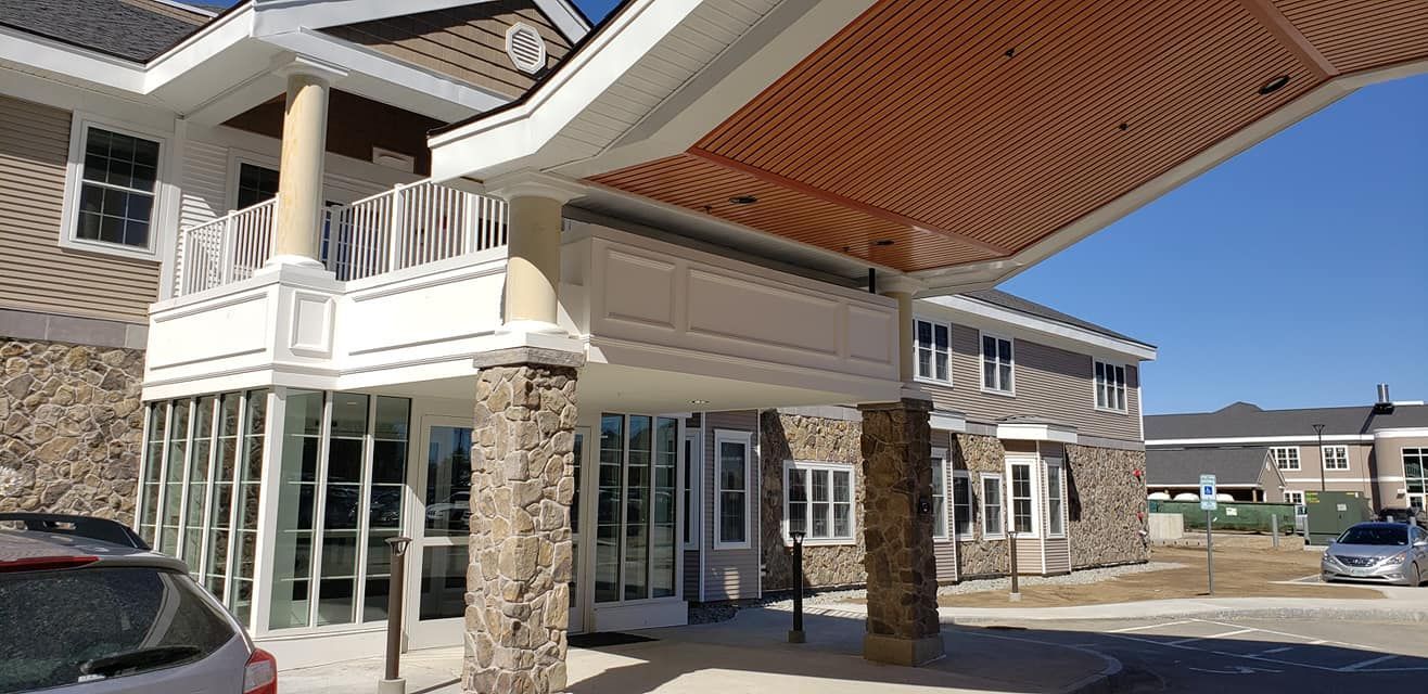 A car is parked in front of a large building.