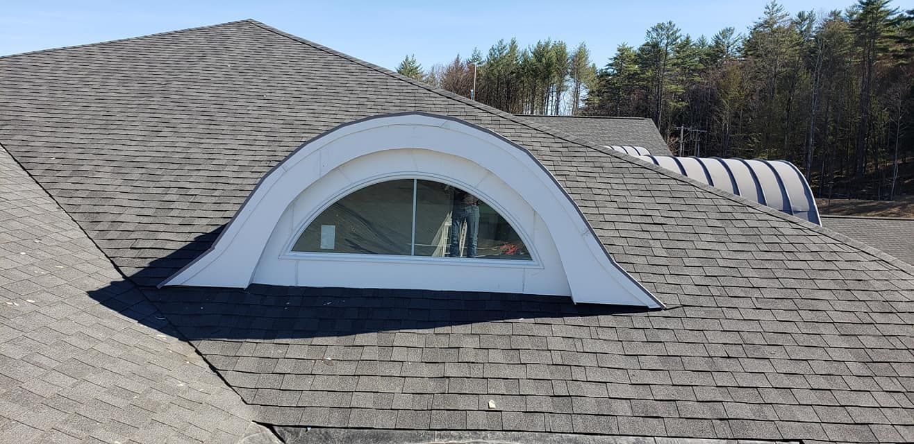 A roof with a window in the middle of it.