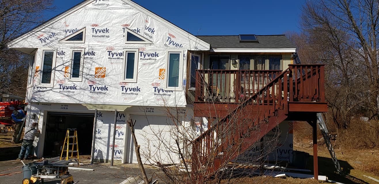 A house is being remodeled with a deck and stairs.