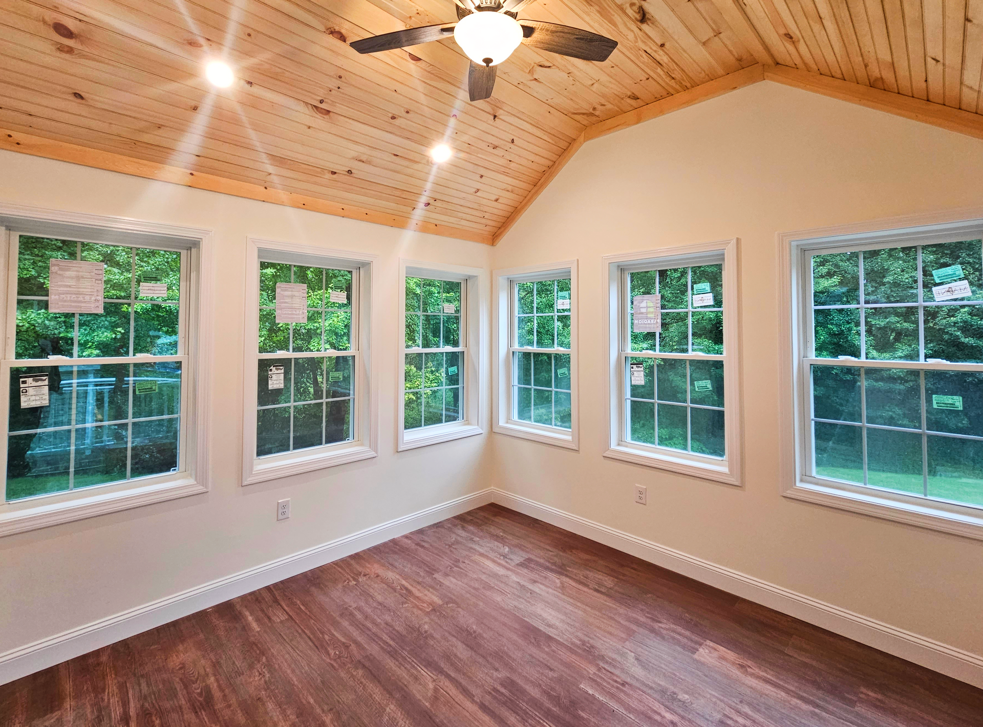 Home additions. Pictured is a sunroom in a new home addition complete with new windows and vaulted ceilings.