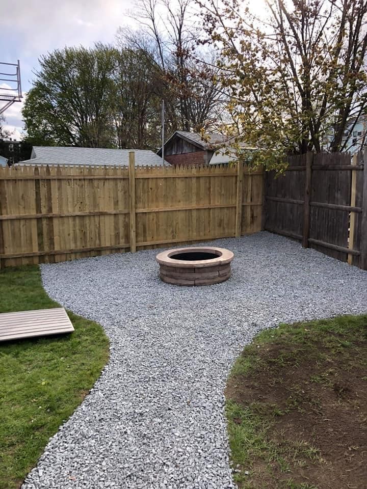 there is a fire pit in the middle of the backyard .