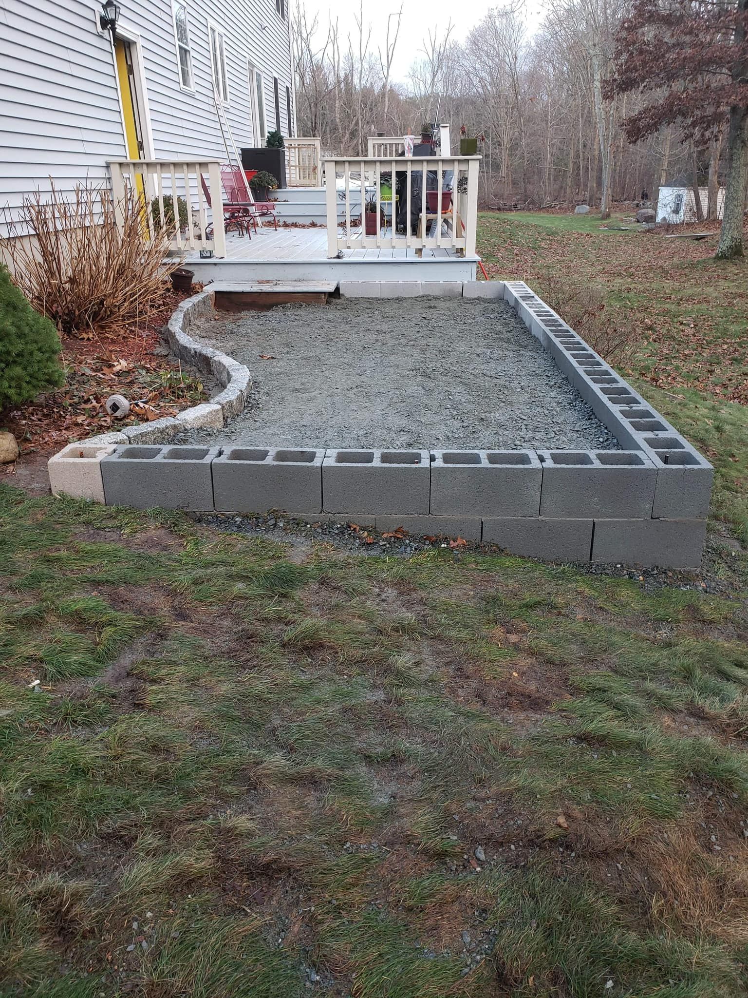 a concrete block walkway is being built in front of a house .