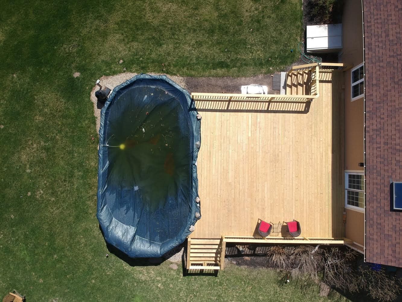 an aerial view of a swimming pool and deck