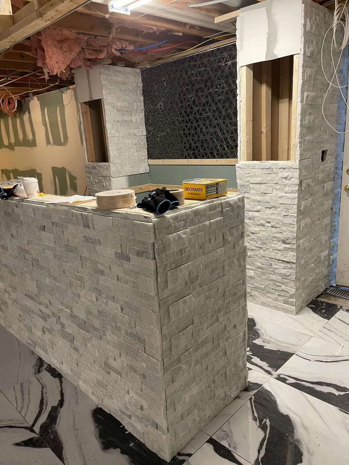 a brick wall is being built in a basement .